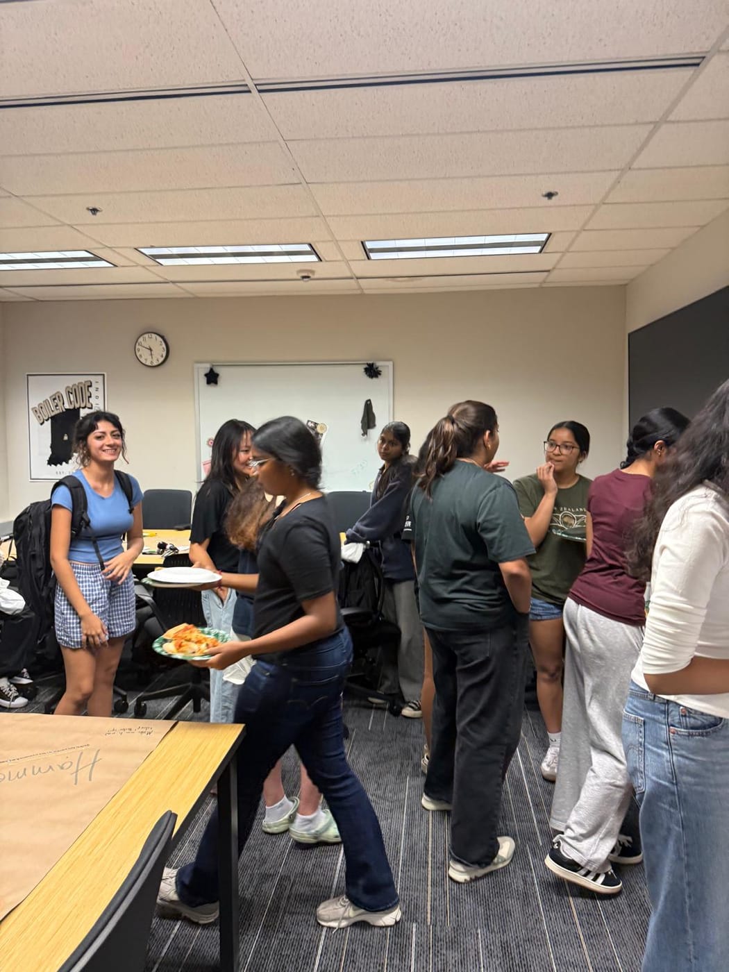 Members catching up over pizza at a CSWN social