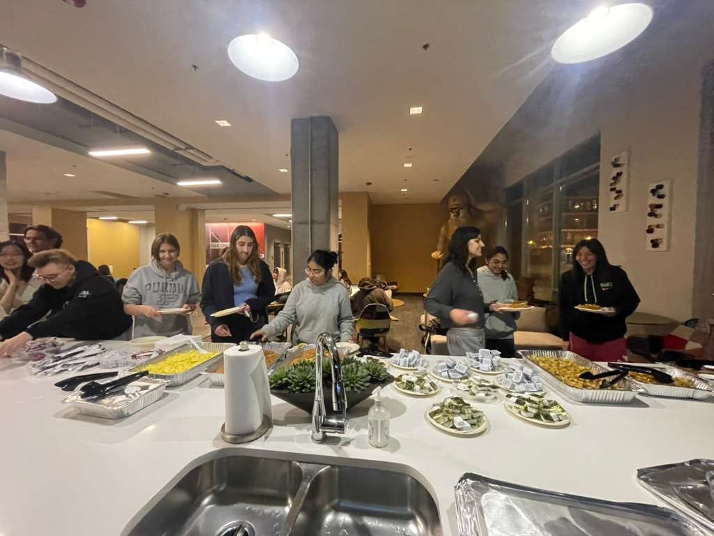 Members going through the buffet line at a CSWN dinner