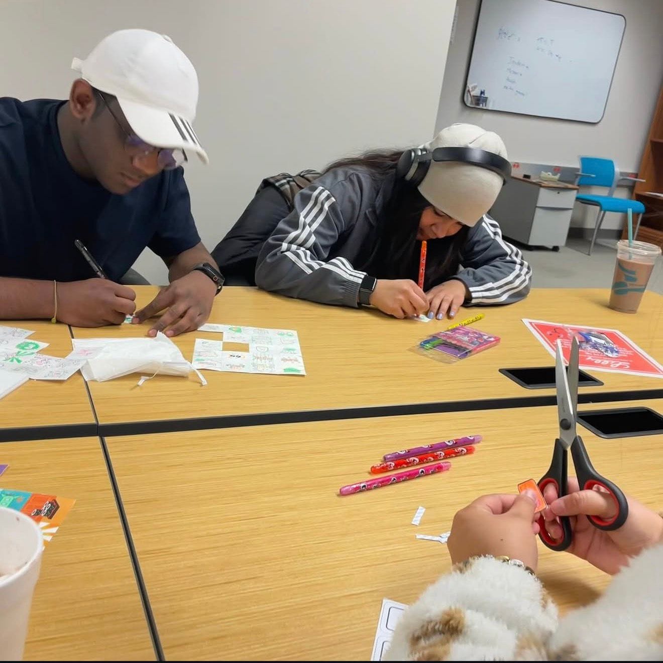 Members making their own stickers at a craft social